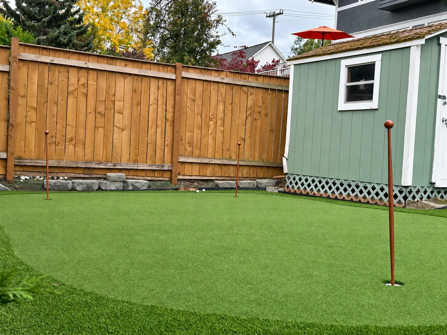 Customer photograph of a completed Wunderland putting green in a landscaped backyard